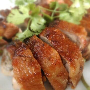 Cayenne roasted quail sliced on a plate.