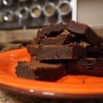 Ultimate fudge keto brownies stacked on a plate.