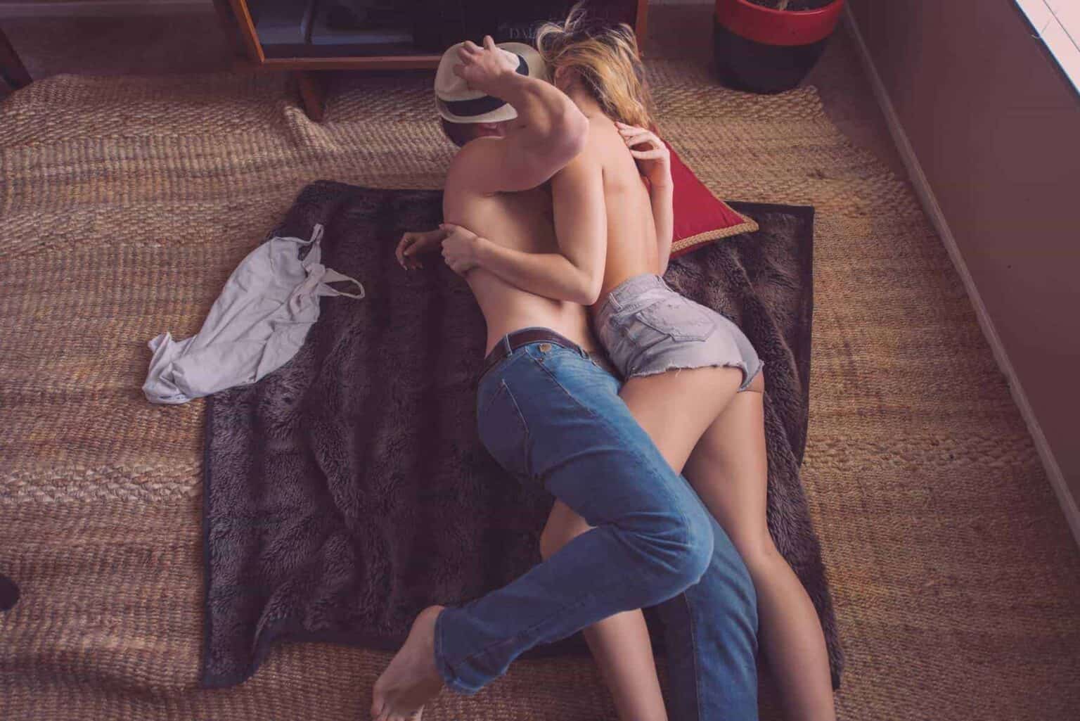 Fertility Awareness Method: Couple laying on a blanket on the floor.