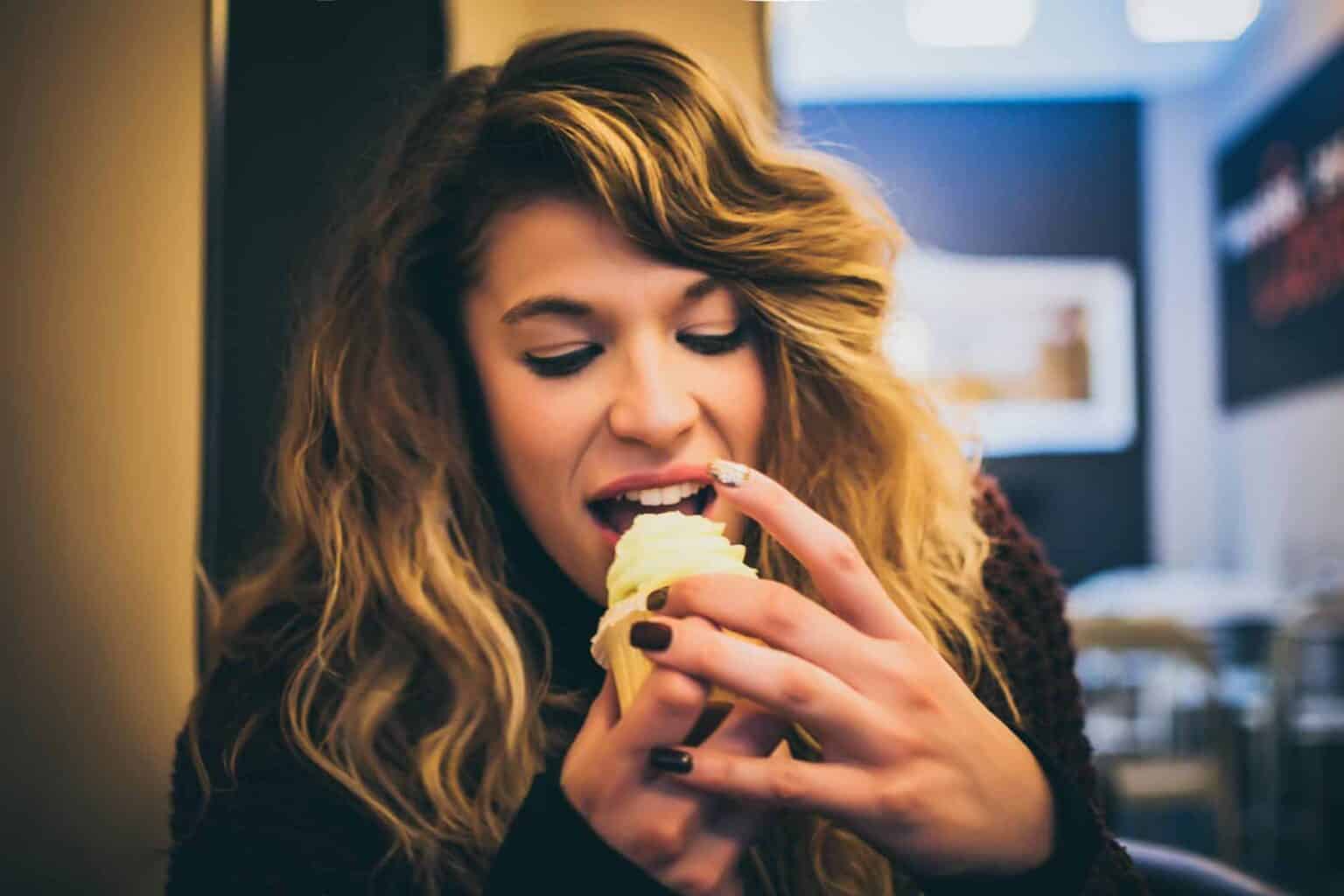 Stress Eating: Woman eating cupcake