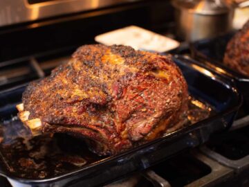 Leftover Prime Rib Recipes: Whole roasted prime rib in roasting pan on oven.