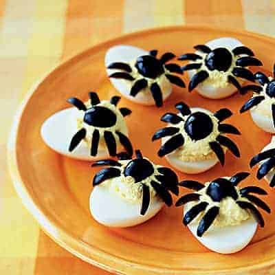 Spider deviled eggs on a plate