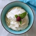 Vanilla Ice Cream in a Bowl Garnished with Raspberry & Mint
