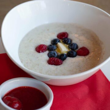 Keto oatmeal with butter and berries on the counter.