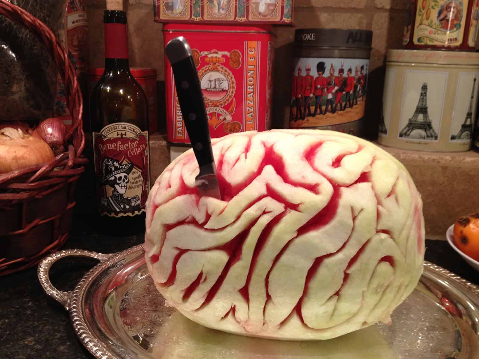 melon brain with a knife in it on a party table