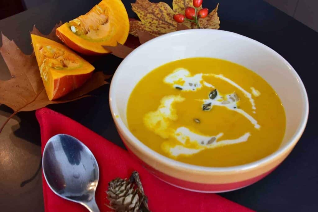 pumpkin sausage soup in a bowl on a fall decorated table