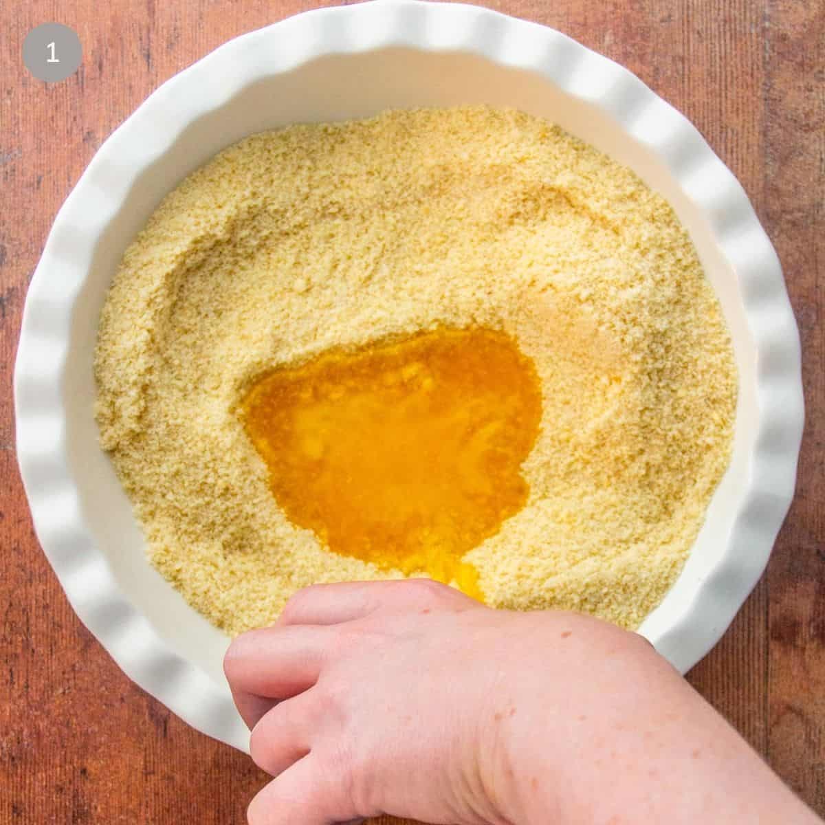 A person stirs ingredients in a bowl, concentrating on achieving a smooth and even consistency.