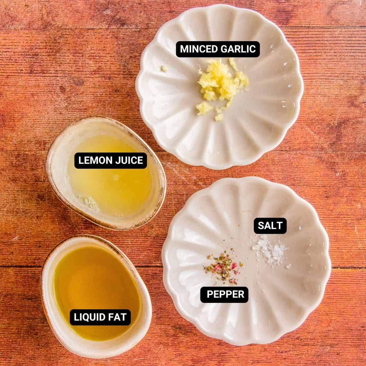 Labeled ingredients for lemon pepper vinaigrette, including liquid fat, lemon juice, minced garlic, salt, and pepper.