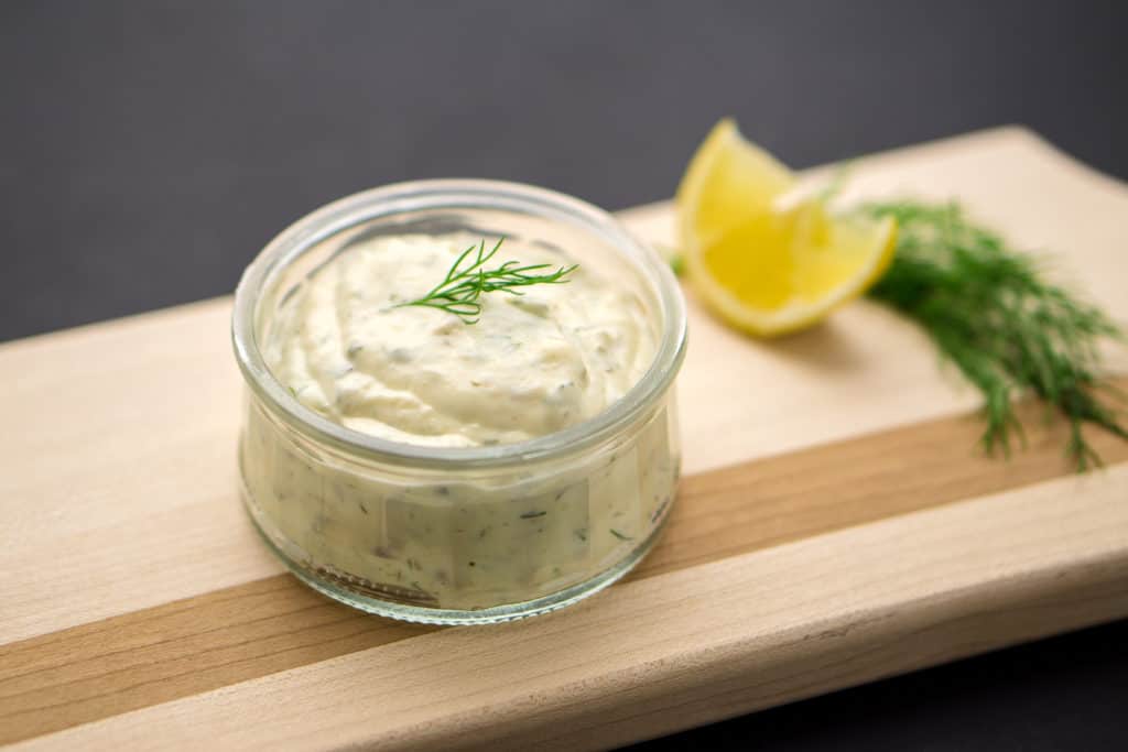 Homemade tartar sauce on black background. 