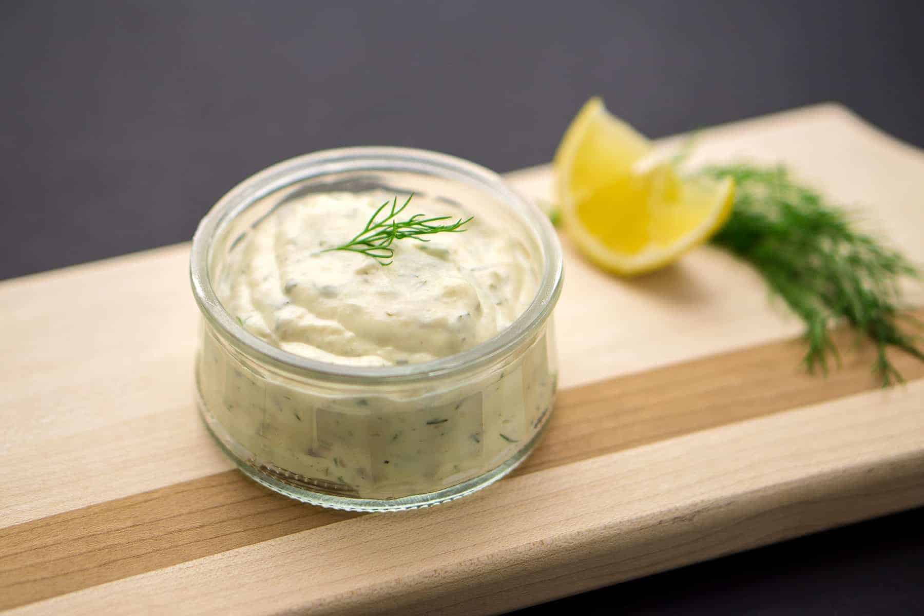 Homemade tartar sauce on black background.