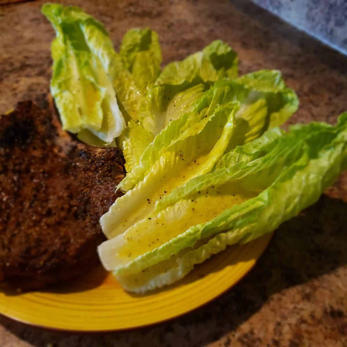 Lemon pepper romaine ribs served alongside a grilled ribeye steak.