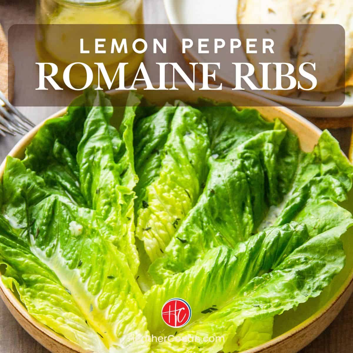 Romaine lettuce leaves dressed with lemon pepper vinaigrette, garnished with herbs, in a bowl.