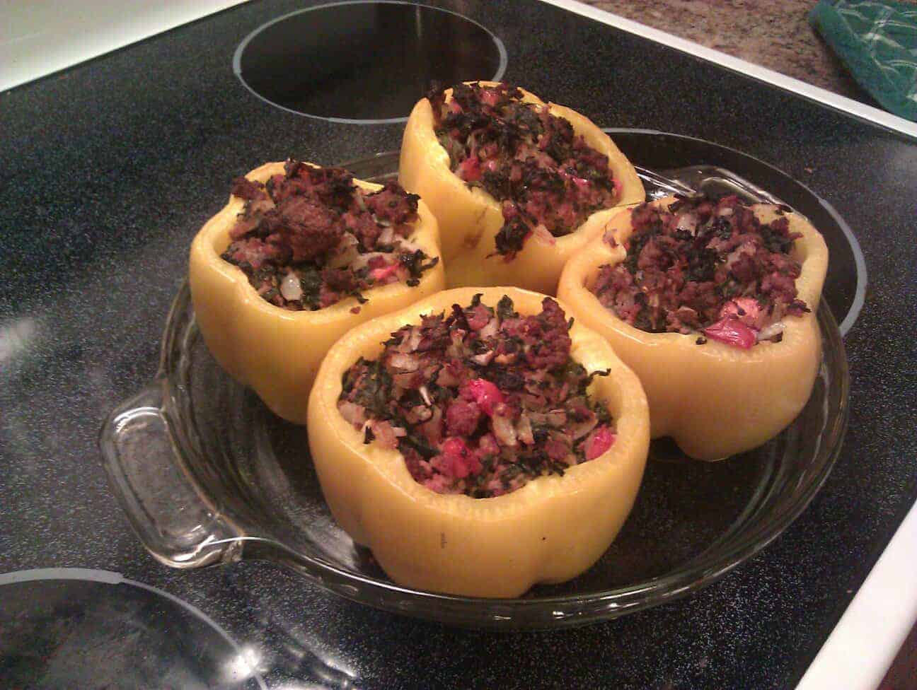 paleo stuffed peppers in a pie plate on stove top