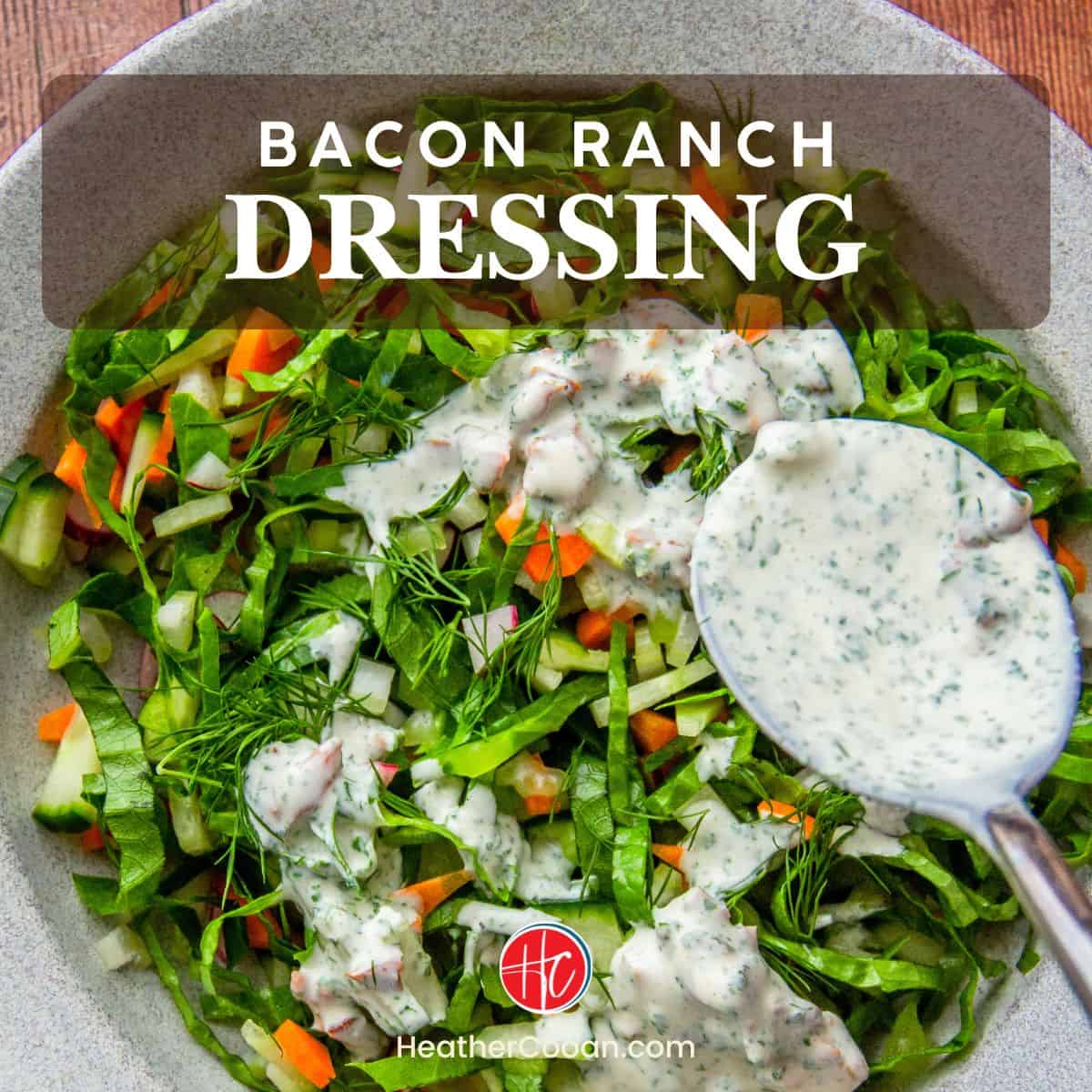 Shredded green salad with carrots and radish, drizzled with creamy bacon ranch dressing from a spoon.