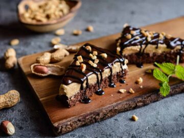 Chocolate Peanut Butter Cream Pie slices on wooden cutting board