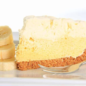Slice of banana cream pie on a plate with a stack of banana slices