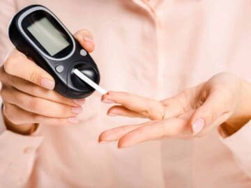 Woman Using a Blood Glucose Ketone Meter