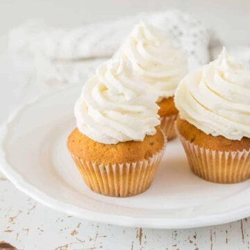 Vanilla cupcakes on white wood background